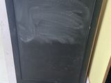a black chalkboard on the wall next to a blackboard
