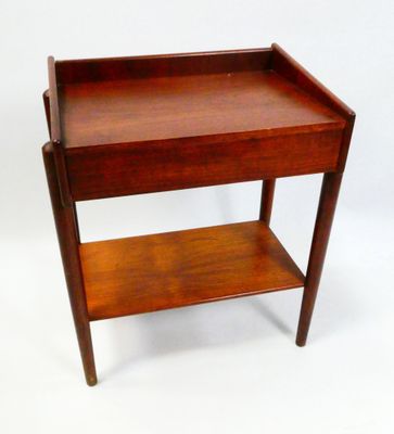a small wooden table with a shelf on it