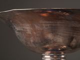a silver bowl sitting on top of a table