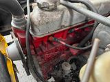 a close up of a motorcycle engine with a hose