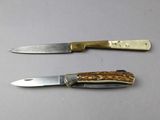 two knives that are sitting next to each other on a table
