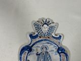 a blue and white plate with a picture of jesus on it