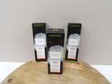 three boxes of garniera on a wooden table