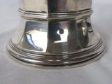 a silver plate on a table with a white table cloth