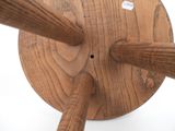 a wooden object that is on a white surface
