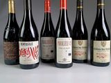several bottles of wine are lined up in a row on a table