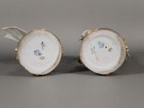 pair of porcelain vases with birds on them on a table