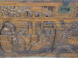 an old wooden trunk with carvings of people and animals on it