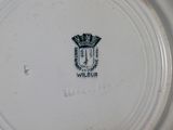 a white plate with a black crown on it