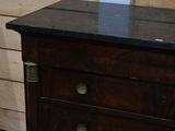 a wooden dresser with a mirror on top of it