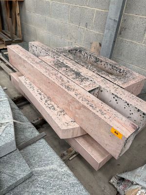 a pile of bricks sitting on a pallet in front of a building