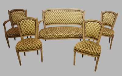 four chairs and a couch in a room with a gray background