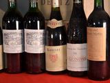 several bottles of wine are lined up on a table