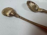 two spoons that are sitting next to each other