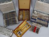 a lot of silverware in a case on a table
