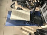 a laptop computer sitting on top of a desk next to a keyboard