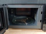 a microwave that is open on a wooden table