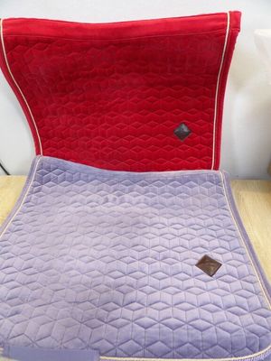 a purple and red chair with a red cushion on it