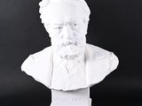 white marble bust of a man with a beard on a black background