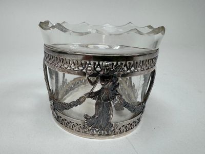 a glass cup with a silver decoration on it