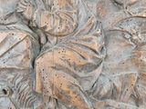 a relief of a man and a woman sitting on a bench