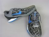 pair of nike shoes with leopard print on them on a white surface
