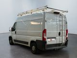a white van with a ladder on the back of it
