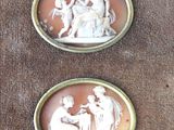 two antique cameos of a man and a woman on a horse
