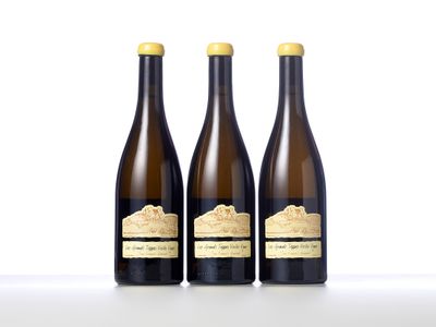 three bottles of wine sitting next to each other on a table