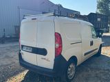 the back of a white van parked in front of a building