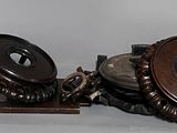 a pair of antique clocks on display on a table