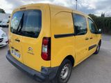 a yellow van that is parked in a parking lot