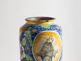 a blue and yellow vase with a picture of a man on it