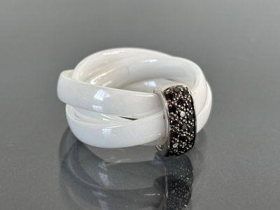 an image of a white and black ring on a table