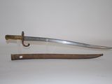 an old sword with a wooden handle on a white surface