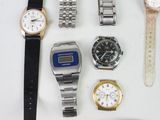 many different types of watches on a white surface