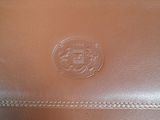 brown leather purse with a logo on the front