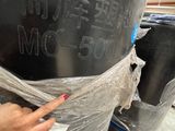 a person that is holding a plastic wrap around a black object