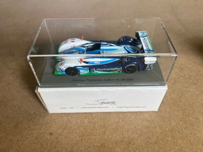 a toy car in a clear box on a table