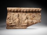 a roman marble relief of a man and a woman on horseback