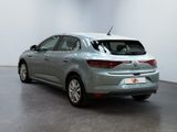 the rear end of a silver car in a white room