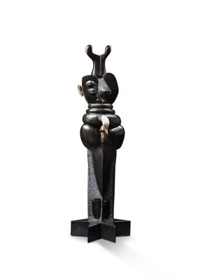 statue of a man sitting on a pedestal with a knife in his hand