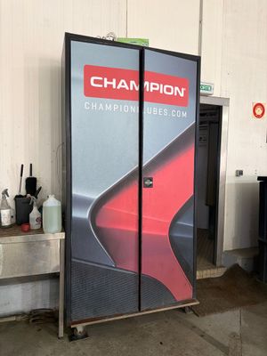 a picture of a refrigerator in a garage with a sign that says champion