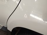 a close up of a white car with a black stripe on it