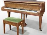 a piano and a stool sitting next to each other