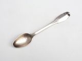 a spoon that is sitting on a white surface