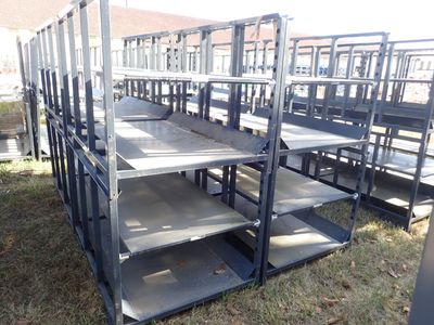 a lot of empty metal shelves in the grass