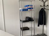 an image of a room with a coat rack and a coat rack