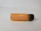 an image of a bottle of orange essential oil on a white surface