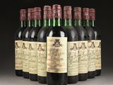 six bottles of wine are lined up in a row on a table